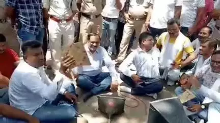 नरसिंहपुर: कांग्रेस ने विद्युत विभाग के अधिकारियों को जमीन पर बैठाकर हाथ पंखे से हवा खिलाई, वीडियो वायरल