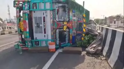 झांसी: डेली के ओवर ब्रिज के ऊपर हाइवे पर कार बचाते-बचाते केले से भरा ट्रक पलटा